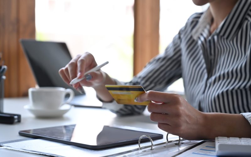 young-woman-holding-credit-card-and-making-online-banking-on-digital-tablet-.jpg